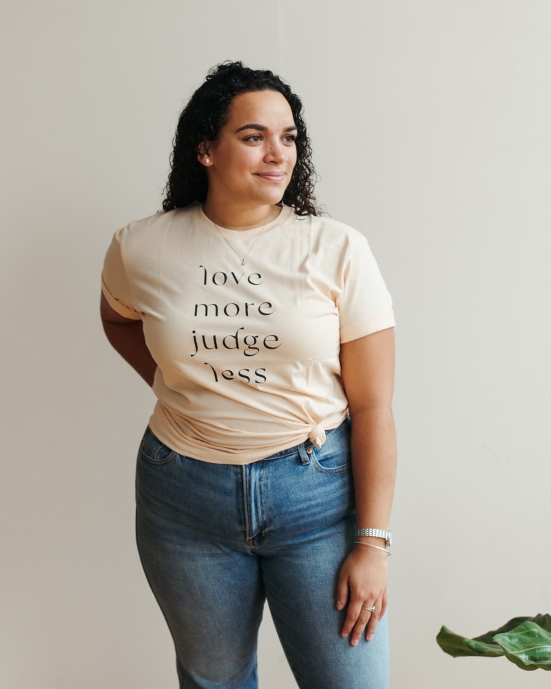 Front of a model wearing a size Large Love More, Judge Less Graphic T-Shirt in Tan by Polished Prints. | dia_product_style_image_id:239742